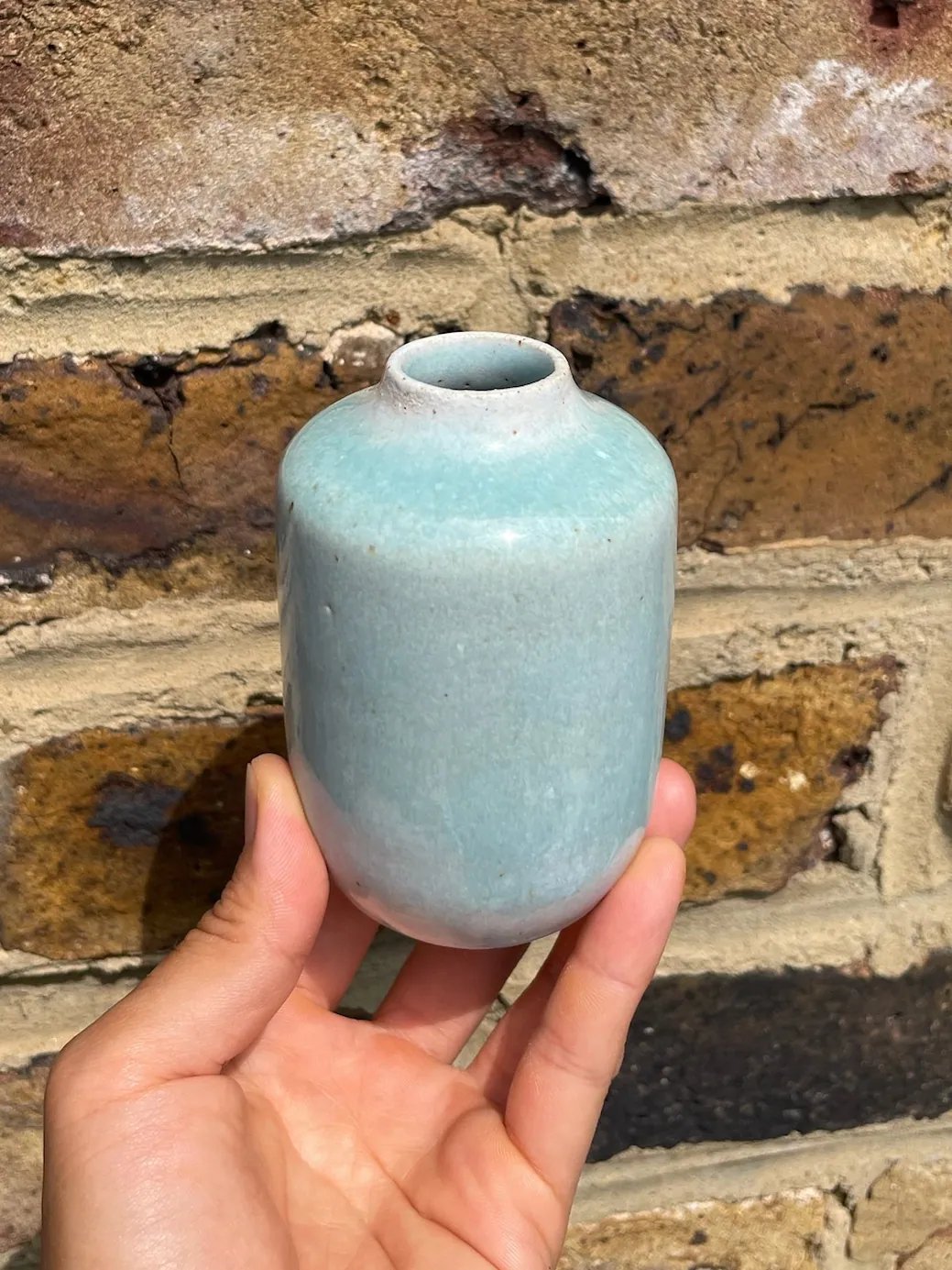Bud vase with rounded shoulders and a narrow neck, pale turquoise, view 1