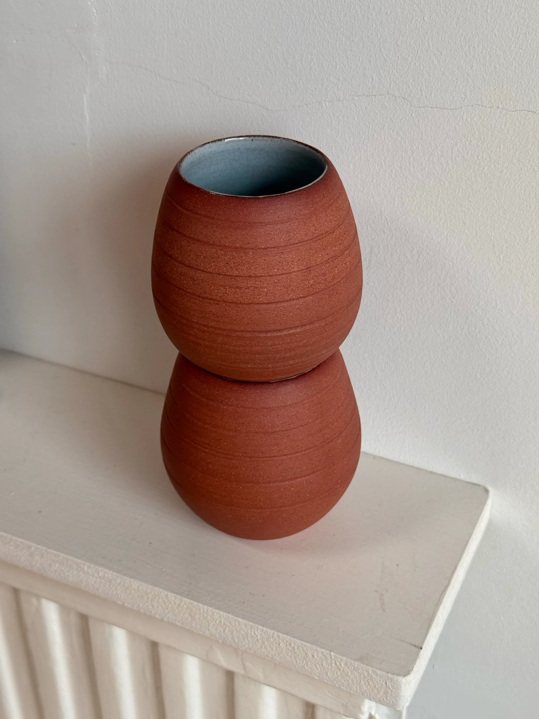 Egg-shaped cups, unglazed red clay outside, pale turquoise inside, view 4