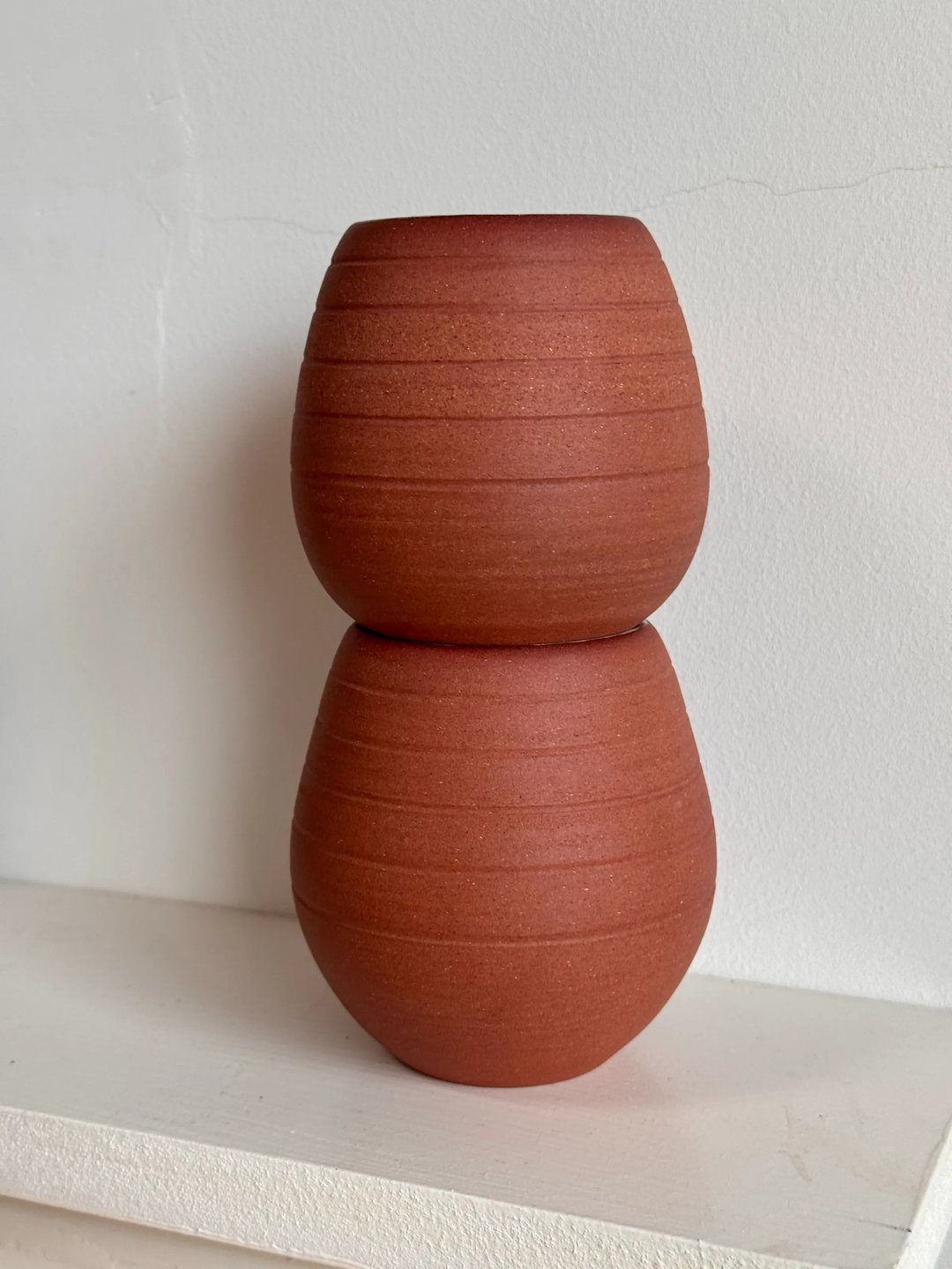 Egg-shaped cups, unglazed red clay outside, pale turquoise inside, view 3