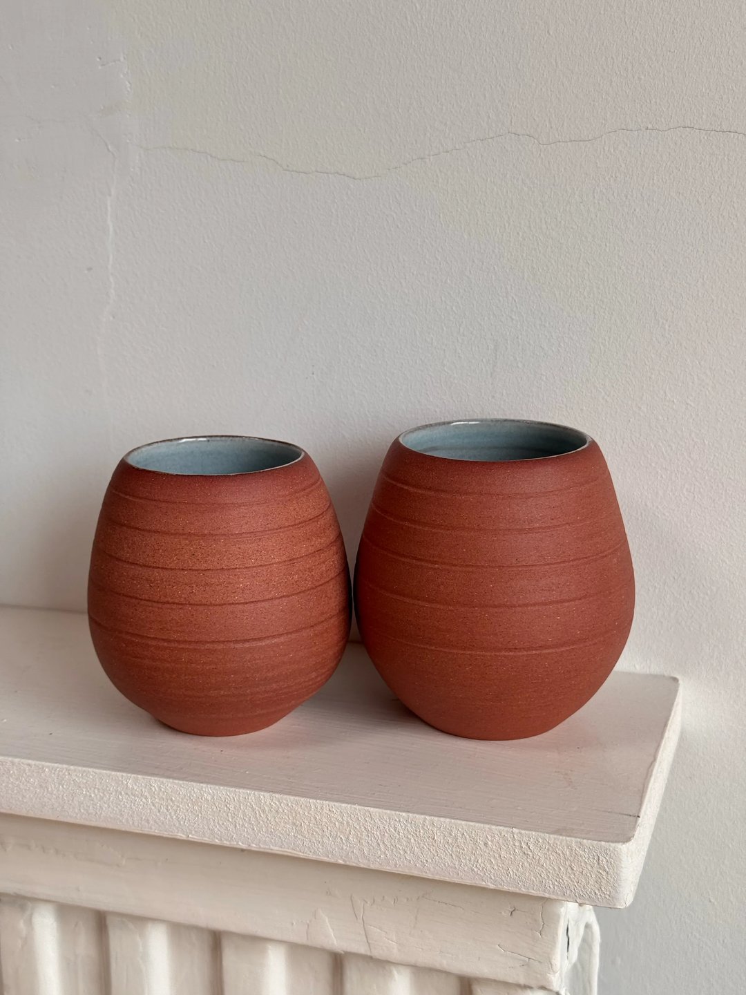 Egg-shaped cups, unglazed red clay outside, pale turquoise inside, view 2