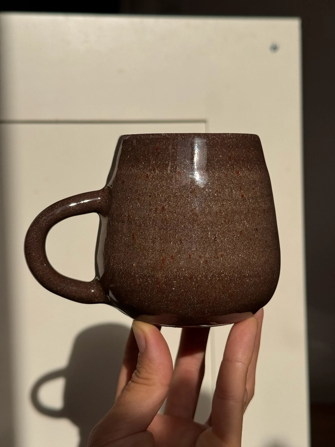 Mugs, dark clay, transparent speckle outside, pale turquoise & lavender on the inside, view 1