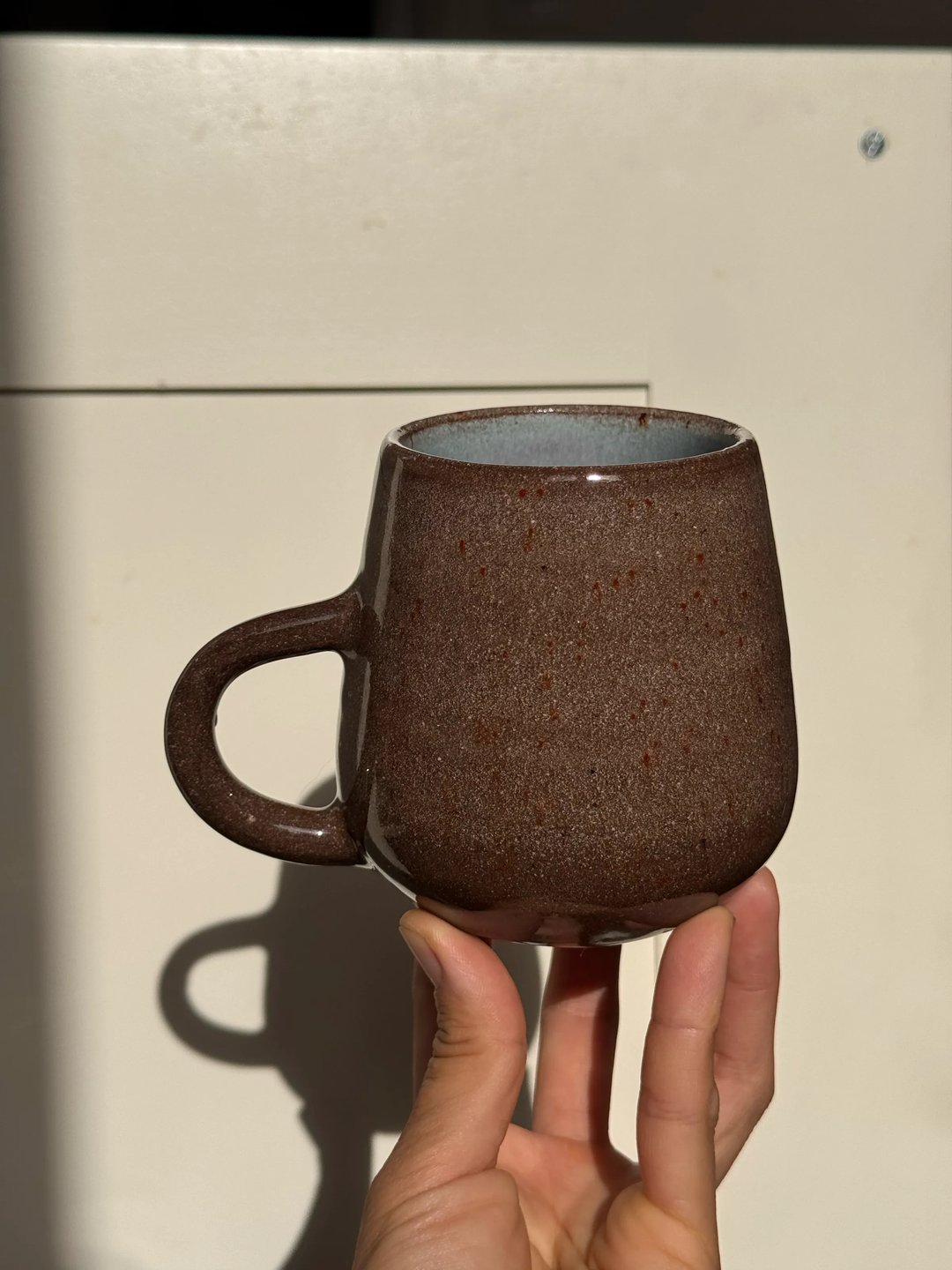 Mugs, dark clay, transparent speckle outside, pale turquoise & lavender on the inside, view 2
