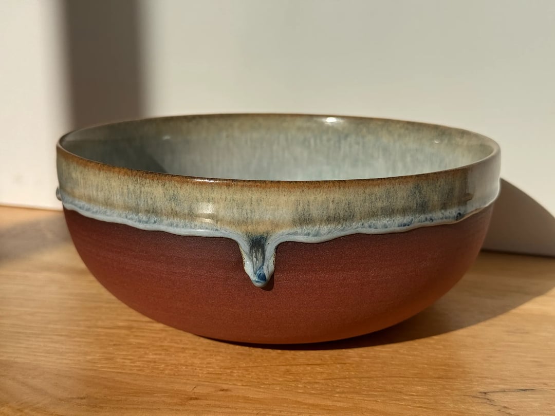 Large bowl with drippy glaze, unglazed red clay outside, misty blue inside, view 2