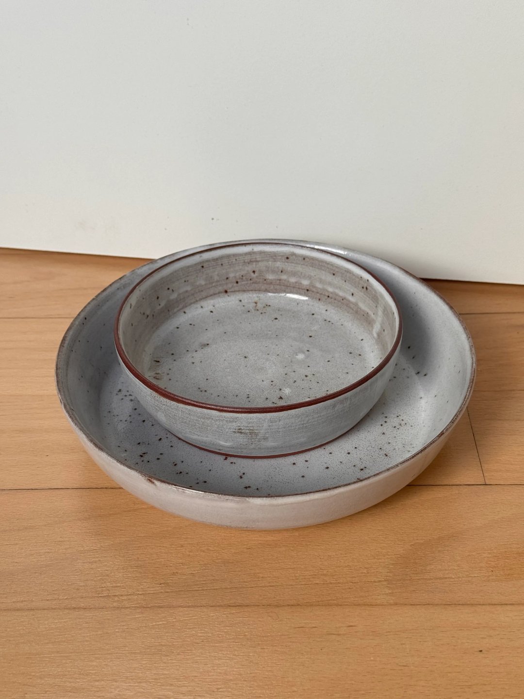 Serving plates, speckled white on red clay, view 1