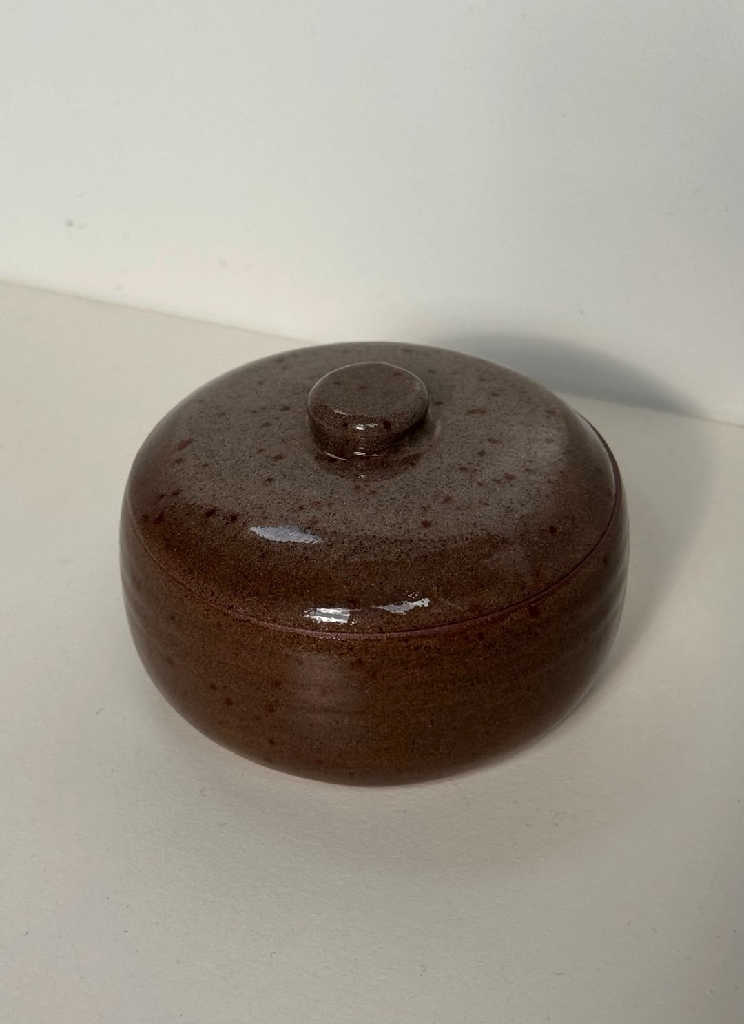 Small lidded jar, speckled brown outside, cream inside, view 2